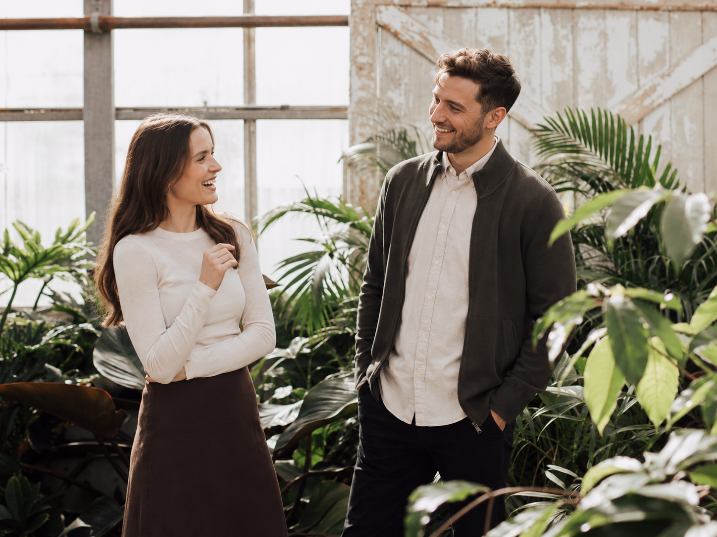 Two colleagues talking in a plant-filled office
